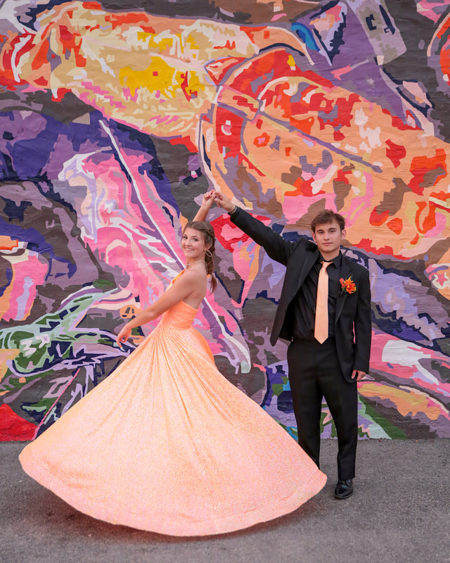Dancers in front of a mural